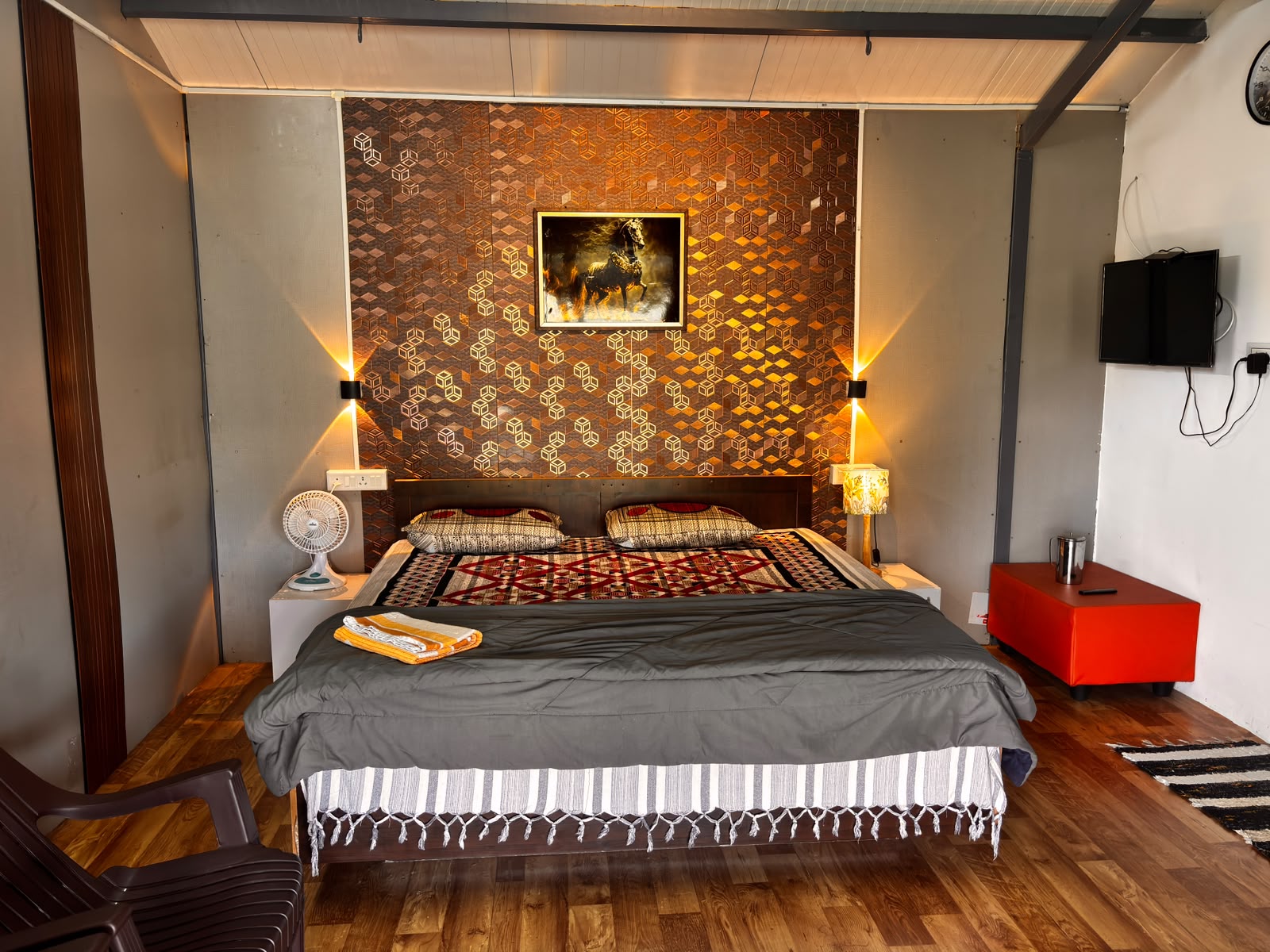Comfortable room with a large bed and warm accent lighting at MG Homestay Kotagiri