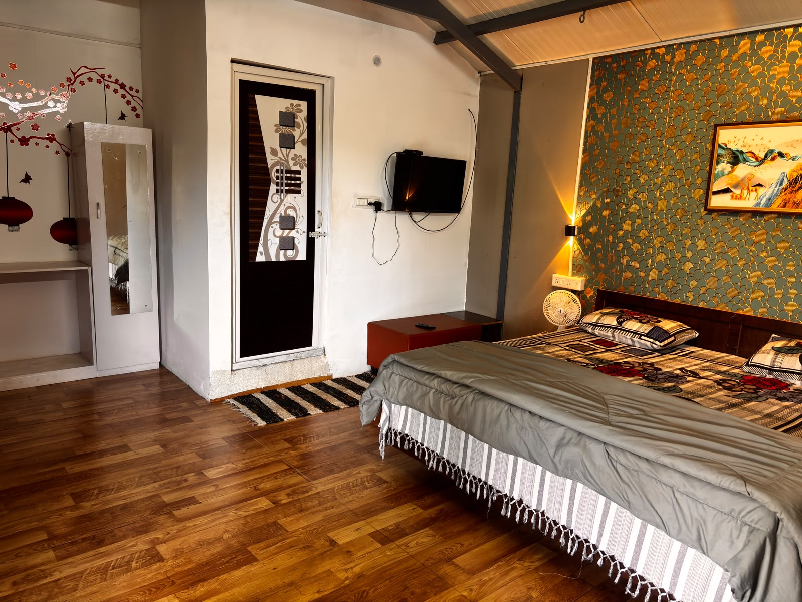Family-friendly homestay room with seating and a television at MG Homestay Kotagiri